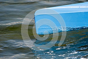 Blue canoe, kajak and rowing on lake water