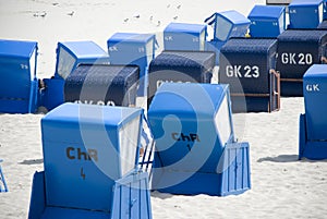 Blue canopied beach chairs at Baltic Sea