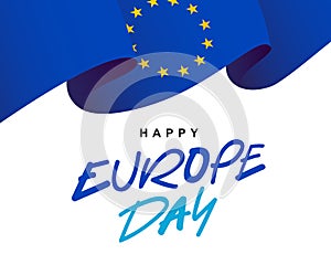 Blue canvas of the European flag with 12 yellow stars flutters in the wind. Stylish lettering - Happy Europe Day