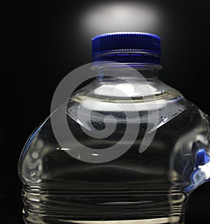 The blue cap tightly closes the neck of the purified water bottle