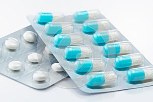 Blue capsule medicines and tablets.