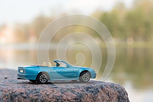 Blue Car against Water Background
