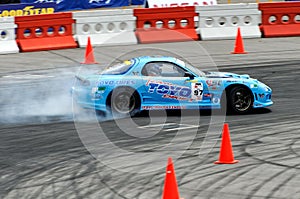 Blue car drifting at a competition