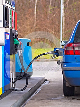 Blue car at gas station