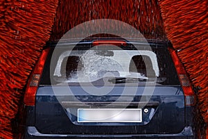 A car inside a car washing machine while it is working