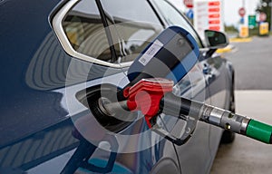 Blue car refueling on a petrol station.