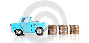 Blue car and a row of dollar coins on a white background