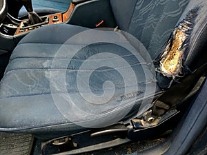 blue car seat with torn upholstery photo