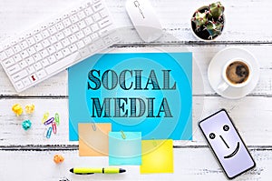 Blue card with the words `Social Media` Smaller cards with space for text, office accessories, cup of coffee, telephone, flower. W
