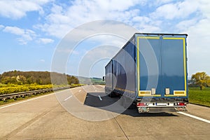 Blue cargo truck on an empty freeway