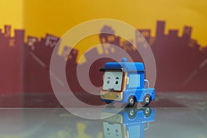 Blue cartoon car toy selective focus on blur city background