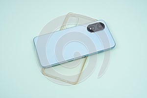 Blue case and transparent case for iPhone, isolated on blue background.