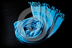Blue cashmere scarf on a black background