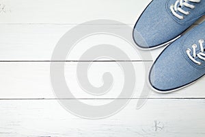 Blue casual sneakers on white background. Copy space for text