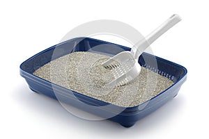 Blue cat litter tray isolated on white with grey litter and a scoop