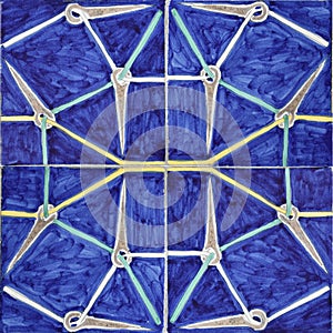 Blue ceramic tile close up with geometric star pattern
