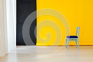Blue chair in the interior of the room with a yellow background