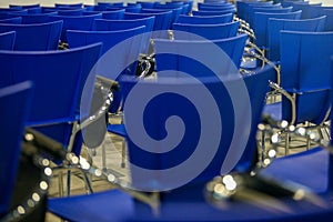 Blue chairs in an auditorium