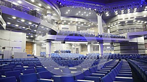 Blue chairs in a concert hall, blurred