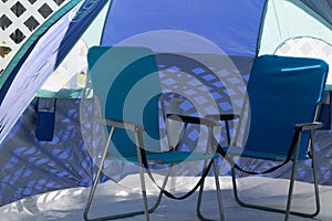 Blue chairs inside vented tent