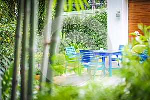 Blue chairs and table set in the garden