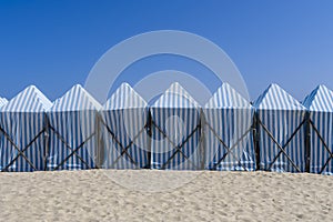 Blue changing huts on the beach in the summertime in Espinho town