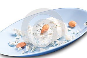 Blue cheese dor blue and almonds on blue plate isolated on white