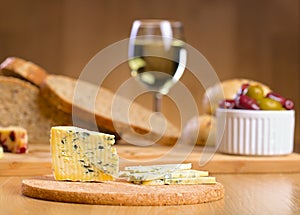 Blue cheese with glass of wine on a background