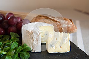 Blue cheese on a plate with grapes.