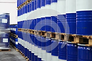 Blue chemical barrels with white stripes line up in chemical storage of industrial factories