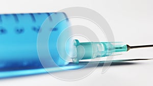 Blue chemical drug in syringe. vaccine study photo