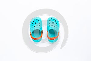 Blue children`s rubber sandals on white background