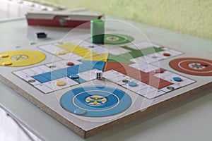 Blue chip at home in a game of parcheesi, entertainment, hobby, fun