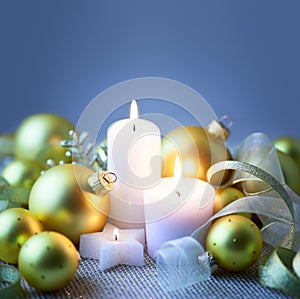 Blue Christmas background with candles , baubles and ribbons