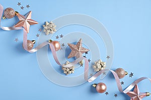 Blue Christmas background with pink decorations, stars, baubles, confetti. Christmas holiday celebration, winter, New Year concept