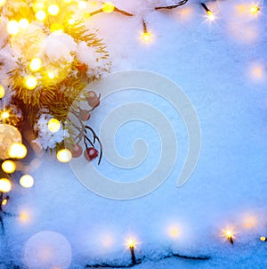 Blue Christmas background with snow fir tree and holidays light.