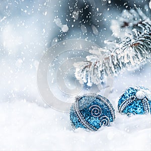 Blue christmas ball on snow with fir branches. Merry Xmas concept