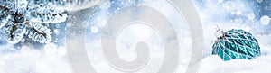Blue christmas ball on snow with fir branches. Merry Xmas concept - panoramic banner