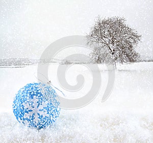 Blue Christmas ball on snowfield