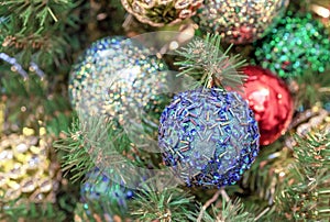 Blue Christmas ball with sparkles and bugles on the Christmas tree