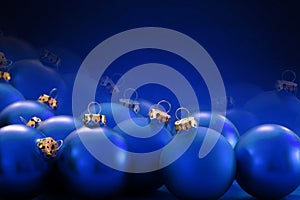 Blue christmas baubles on blurred blue background, copy space