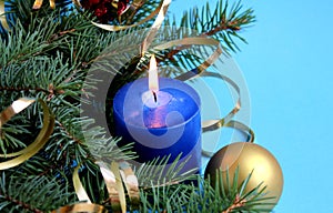Blue candle lit on holiday christmas background