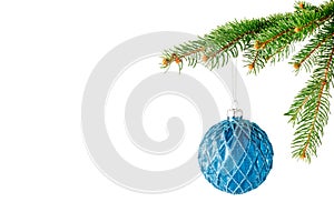 Blue Christmas glass ball hanging on fir tree branch isolated on white