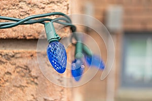 Blue Christmas lights on a brick wall - intricate patterns - festive ambiance