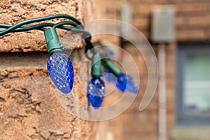 Blue Christmas lights on a brick wall - intricate patterns - festive ambiance