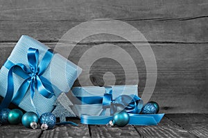 Blue christmas presents on wooden grey shabby background.