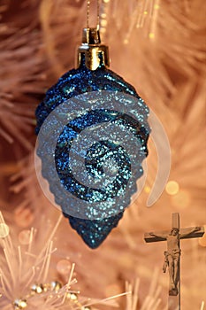 Pine cone Christmas ornament with lights and crucifix photo
