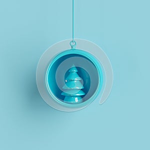 Blue Christmas tree ornament in blue glass on blue background