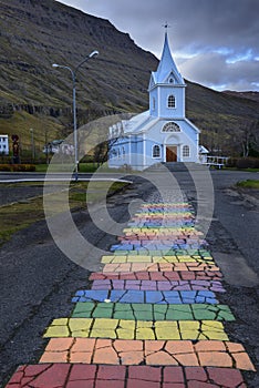 Blue Church and rainbow road in Seydisfjordur