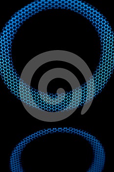 Blue circle in dark. LED glow. Abstract background on black. Mesh structure